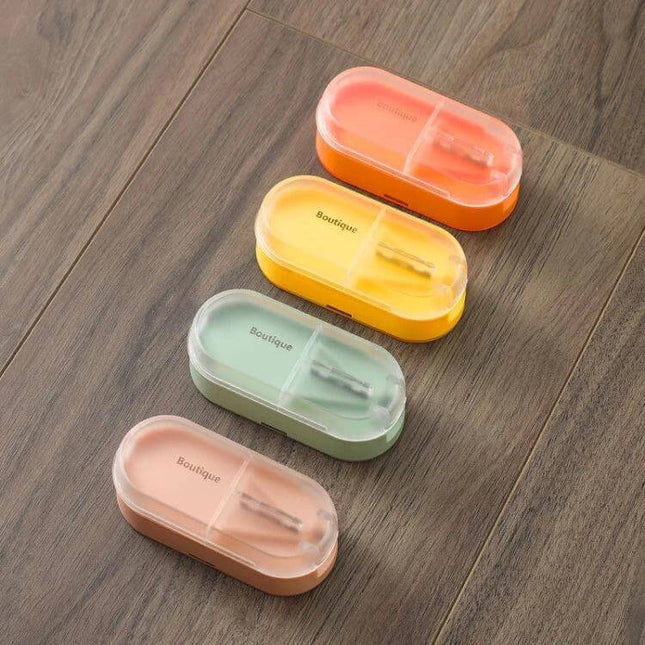 Home Transparent Tablet Divider Medicine Box With Compartments showing four colorful transparent pill boxes with built-in cutter and compartments on wooden surface