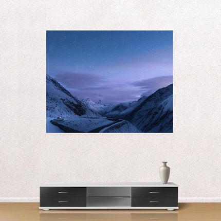 Portable Folding Projection Screen for Home Use displaying snowy mountain night scene over a modern TV console