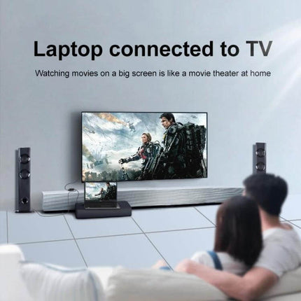 HDMI to VGA Adapter with Audio for Monitors and Projectors showing a laptop connected to a TV for big-screen movie viewing with audio
