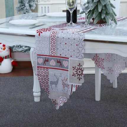 Christmas Table Runner 180 x 35 cm Flower Lattice Print on dining table with reindeer motifs and festive centerpiece