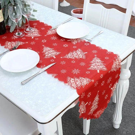 Christmas Table Runner 180 x 35 cm Flower Lattice Print red scalloped runner with white tree motifs on dining table