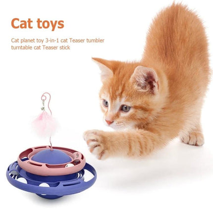 Colorful Tumbling Cat Toy for Everyday Indoor Playtime - orange kitten pawing at blue and pink tumbler with balls and feather bell