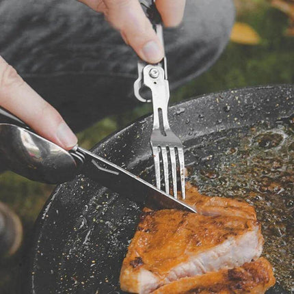 6 In 1 Folding Tableware Set Detachable Utensils For Outdoor Camping shown cutting and serving steak with folding knife and fork in pan
