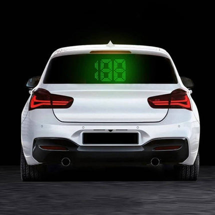 GPS Rear Window Speedometer for Vehicle Safety Monitoring showing bright green LED speed display on rear window of white car