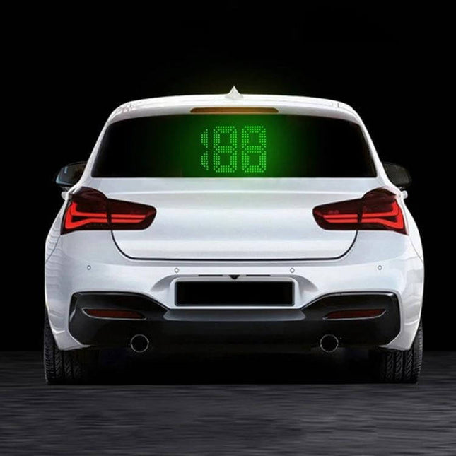 GPS Rear Window Speedometer for Vehicle Safety Monitoring showing bright green LED speed display on rear window of white car