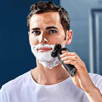 Replacement Razor Shaver Blade Head For Philips Shavers installed on electric shaver used by man applying shaving cream for close, clean shave