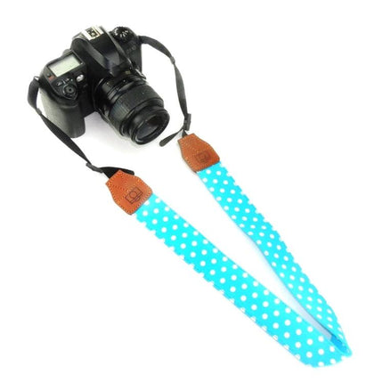 Retro Style Camera Shoulder Strap for Everyday Use with turquoise polka dot fabric and brown faux leather ends attached to DSLR