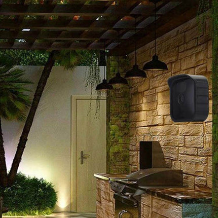 Silicone Protective Cover for Blink Security Cameras in Black installed on outdoor wall near grill to protect camera from rain and scratches