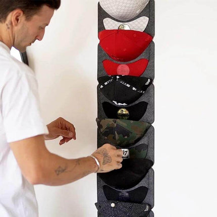 Felt Baseball Cap Display Stand Non-Woven Hanging Storage Bag For Hats hanging on wall with multiple caps in vertical organizer
