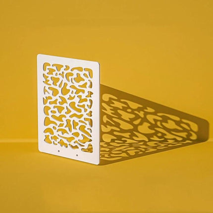 Light Shadow Board for Still Life and Portrait Photography: white patterned board casting decorative shadow on yellow background, waterproof prop for studio lighting