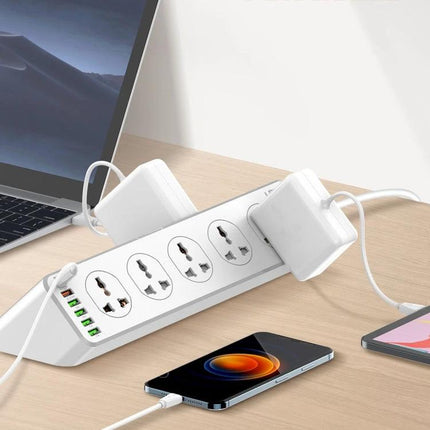 LDNIO Multifunctional Charging Socket for Home, Office, and Travel on desk with laptop, phone and multiple devices plugged in