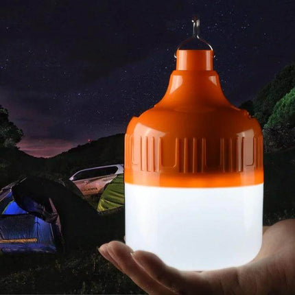 USB Charging LED Bulb for Night Markets and Camping hanging orange rechargeable camping light in hand providing bright tent illumination