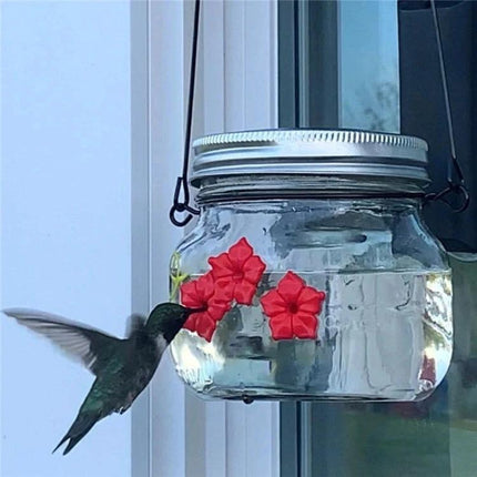 Outdoor Hanging Feeder for Hummingbirds in Your Backyard - clear hanging jar feeder with red flowers and hummingbird