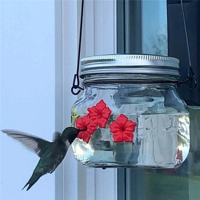 Outdoor Hanging Feeder for Hummingbirds in Your Backyard - clear hanging jar feeder with red flowers and hummingbird