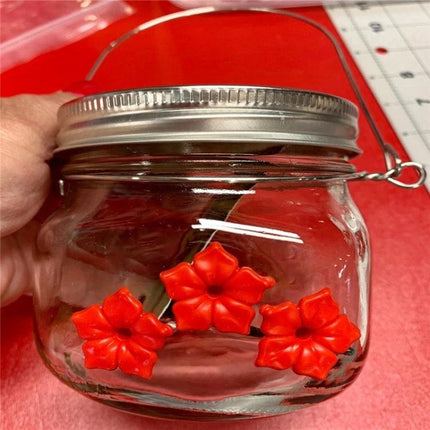 Outdoor Hanging Feeder for Hummingbirds in Your Backyard - durable plastic hanging jar feeder with red flower ports and secure metal ring