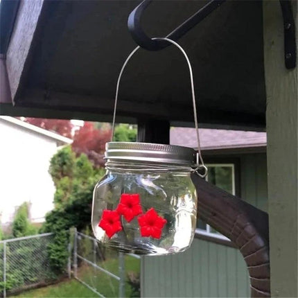 Outdoor Hanging Feeder for Hummingbirds in Your Backyard - durable plastic jar feeder with red flower ports and secure hanging ring