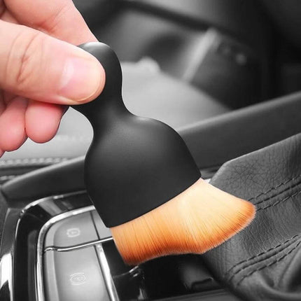 Car Air Conditioner Vent Cleaning Brush with Soft Synthetic Fibers gently cleaning car interior vents and controls to remove dust without scratching
