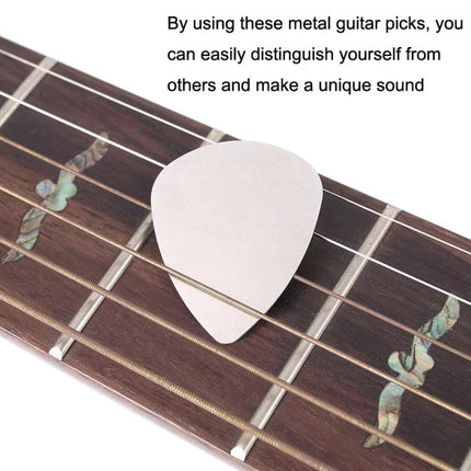 Stainless Steel Guitar Picks for Everyday Music Practice Sessions shown on acoustic guitar fretboard for reliable tone and grip