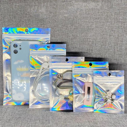 Aluminum Foil Self-Sealing Bags for Electronics Storage showcasing holographic self-sealing bags holding phone, charger, earphones and small accessories
