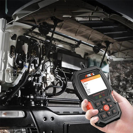 Essential ANCEL Scanner for Routine Truck Maintenance - hand-held diagnostic tool checking truck engine and brake systems under open hood