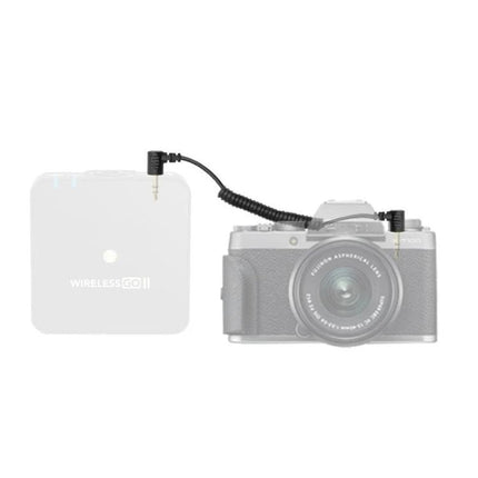 Adapter for Everyday Mobile Microphone Connections showing compact coiled cable linking a wireless transmitter to a camera for mobile podcasting and vlogging