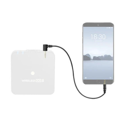Adapter for Everyday Mobile Microphone Connections showing a black 3.5mm adapter cable connecting a smartphone to a wireless microphone receiver for on-the-go recording
