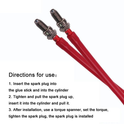 Rubber Tool for Spark Plug Handling in Car Maintenance - red flexible stick holding two spark plugs for safe insertion and removal