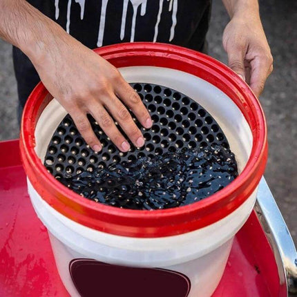 Aquarium Gravel Isolation Net for Sediment Filtering, Large 26cm held over a bucket to trap gravel and separate sediment during cleaning