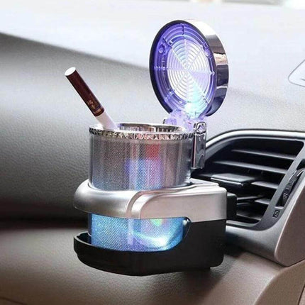 Car Air Conditioner Outlet Ashtray With Blue LED Light mounted on dashboard vent, clamshell design trapping ashes and glowing blue interior illumination