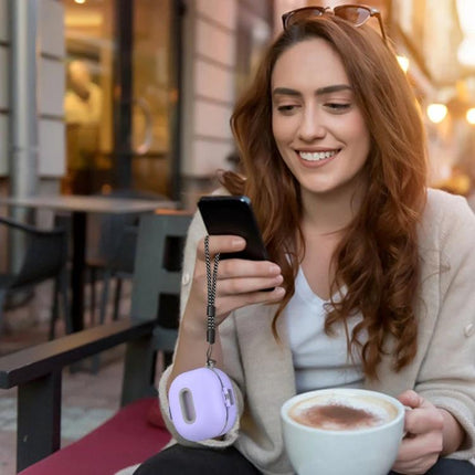 Essential Case for Samsung Earbuds in Everyday Activities: woman using phone at cafe with purple protective Samsung earbuds case on wrist, waterproof TPU shell