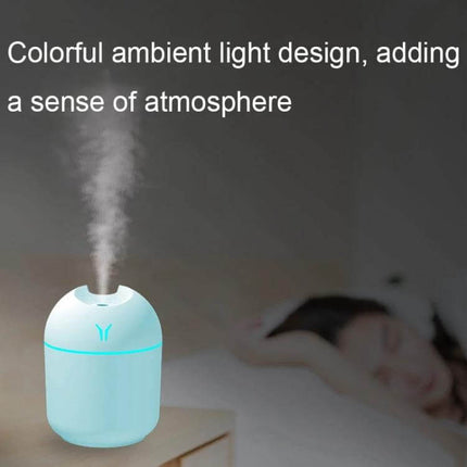 USB Mini Desk Humidifier 250ml With Colorful Night Light on bedside table emitting mist with soft blue ambient glow