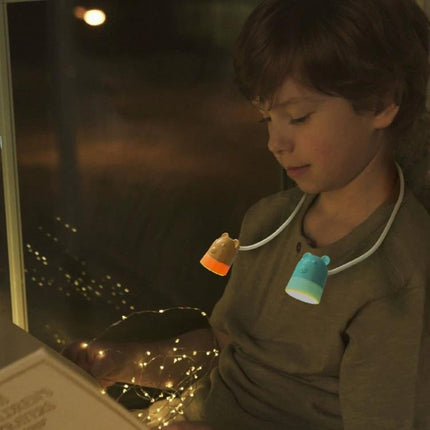Hanging Neck Lamp for Bedtime Reading and Daily Use - child reading hands-free with flexible neck lamp worn around neck for bedside use