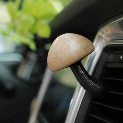 Mushroom Car Air Vent Aromatherapy Ornament Solid Wood mounted on car vent releasing subtle ocean fragrance during commute