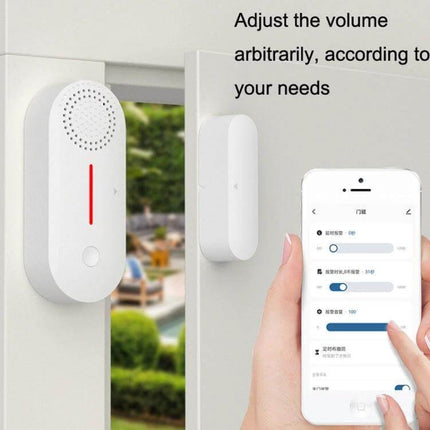 Tuya WiFi Enabled Door and Window Security Sensor with Sound and Light Alarm mounted on a door frame showing app alert and volume settings