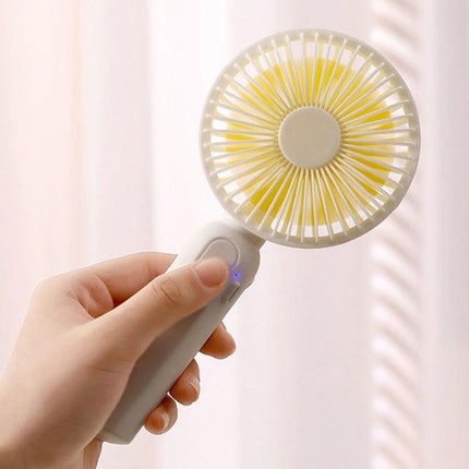Portable Handheld Mini Fan for Outdoor and Indoor Cooling in hand showing compact white and yellow bladeless design