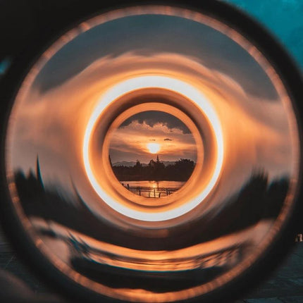 Swirl Halo Special Effect Filter for SLR Photography, 77mm showing sunset vortex halo effect framed through filter glass