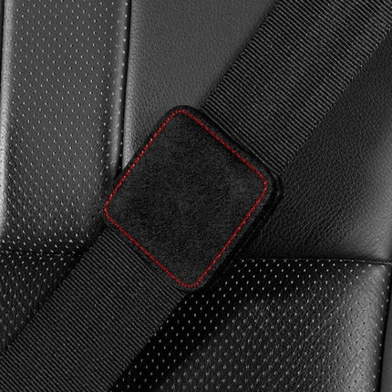Car Seat Belt Limiter Elastic Adjuster Magnetic Fixation on black car seat showing suede pad with red stitching for comfortable belt position