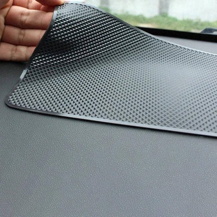 Car Anti Slip Mat For Center Console And Instrument Panel Medium placed on dashboard holding phone and keys, textured reusable PVC grip