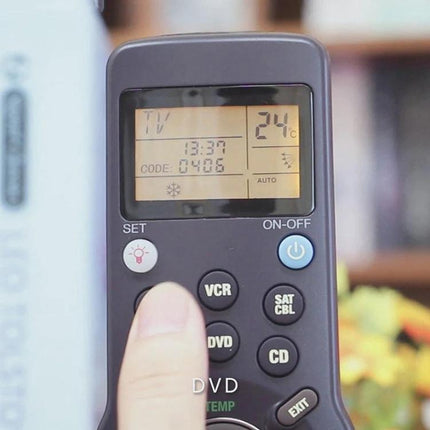 Chunghop 6-in-1 Universal Learning Remote Control for Devices handheld showing LCD and button being pressed