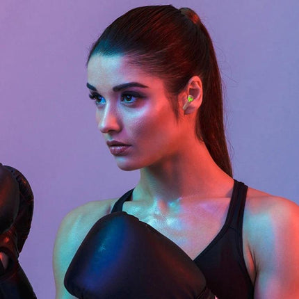 Wireless Bluetooth In-Ear Earphones With Low Latency For Commuting shown in compact sporty earbuds worn by female boxer