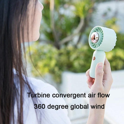 Handheld Mini Fan with Duck Design for Portable Cooling held outdoors showing compact portable cooling and three-speed adjustable airflow