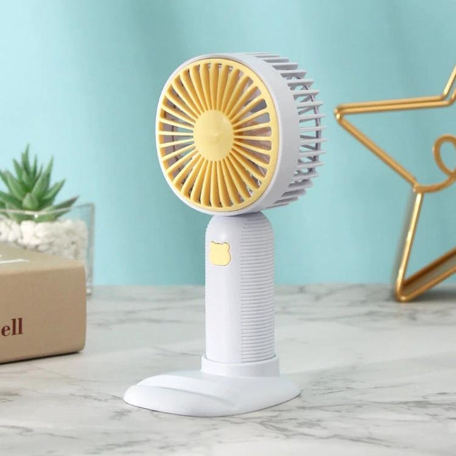 Handheld Portable Fan for Everyday Cooling and Travel Use compact white and yellow fan with stand and phone holder