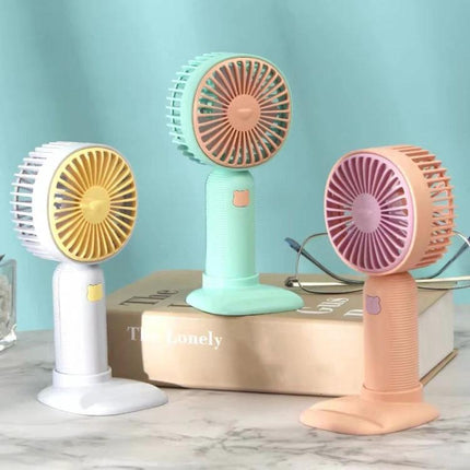 Handheld Portable Fan for Everyday Cooling and Travel Use - compact pastel handheld fan with stand and phone holder