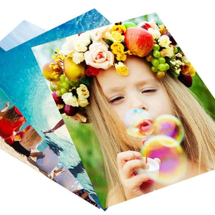 A4 High Gloss Coated Paper for Double-Sided Color Laser Printing showing vibrant double-sided photo prints of a girl blowing bubbles