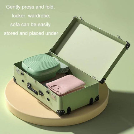 Compact Portable Folding Washer For Small Loads Lake Blue shown folded inside a suitcase with baby clothes and towels for compact storage