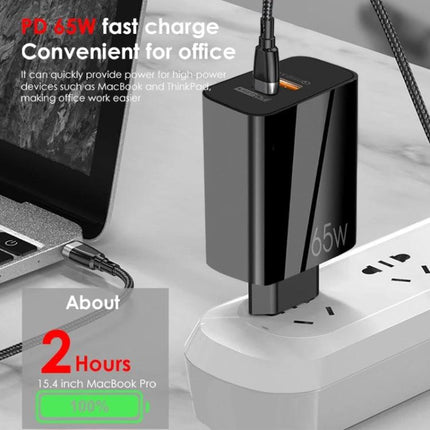 Charger for Everyday Device Power Needs at Home and Travel 65W black fast charger plugged into power strip next to laptop