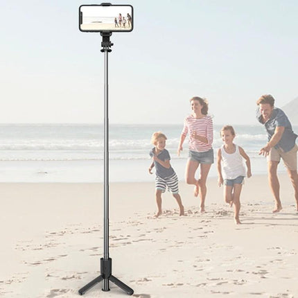 CYKE Tripod for Everyday Phone Photos and Videos set up on beach capturing a family running hands-free with remote