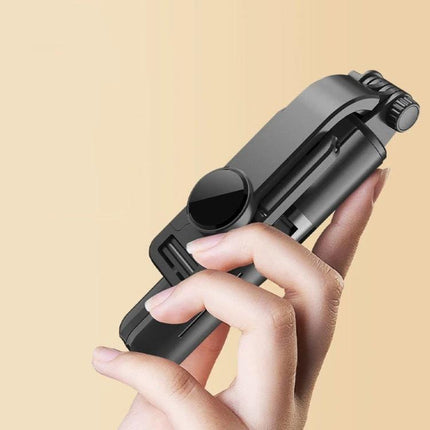 CYKE Tripod for Everyday Phone Photos and Videos held folded in hand, compact travel phone tripod with built-in remote for steady shots