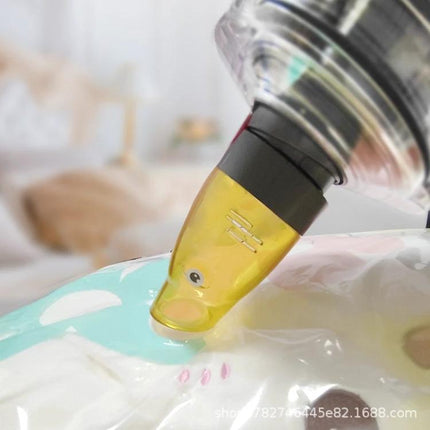 Dyson Suction Tip Adapter for Vacuum Storage Bags attached to vacuum removing air from storage bag nozzle close-up