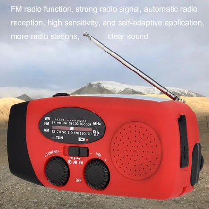 HanRongda HRD-902 Emergency Solar Radio for Disaster Use - red portable emergency radio with antenna and tuning knobs in outdoor landscape